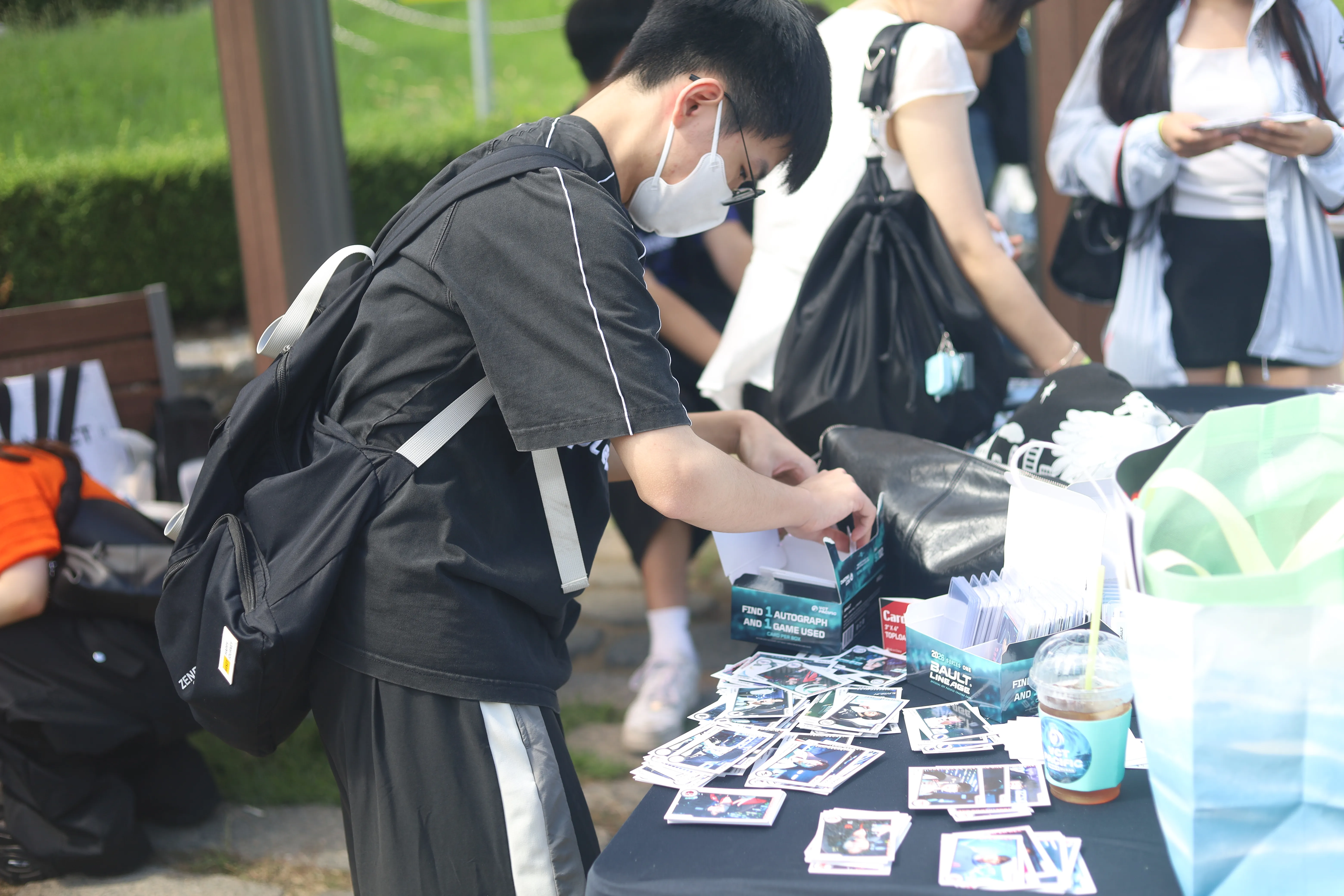 A fan browses player cards at a Bault display.